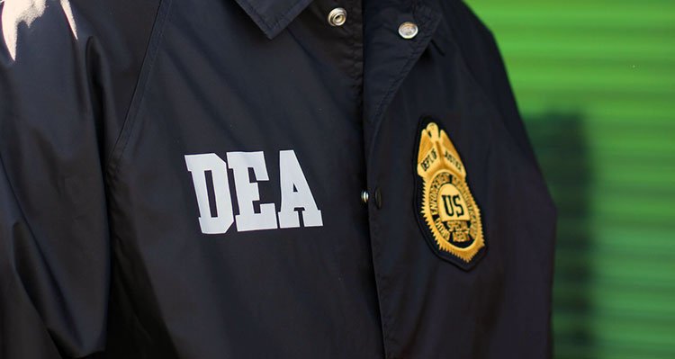 State and Federal Agents Seize THC Products In Arkansas DEA patch and badge on an officer's coat.