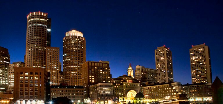 Buildings of Boston with a night-blue sky.